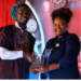 FeJAL President Lisa Diasay presents an award during the District 11 Students Union academic awards ceremony in Monrovia.