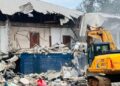 Excavator demolishes the former CDC headquarters building in Monrovia amid ongoing legal disputes over the disputed property