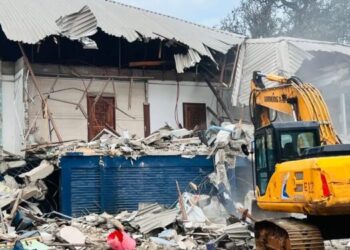 Excavator demolishes the former CDC headquarters building in Monrovia amid ongoing legal disputes over the disputed property