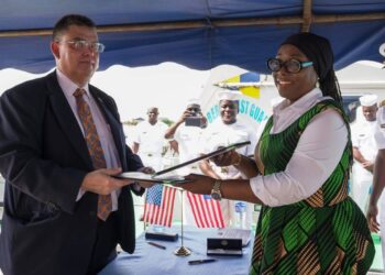 Liberian Foreign Minister Sara Beysolow Nyanti and a U.S. diplomat signing the Shiprider Agreement at the Liberia Coast Guard Base