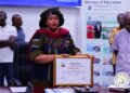 Education Minister Jarso Maley Jallah displaying an AFTRA Fellowship award in Monrovia