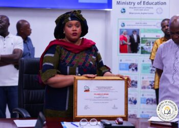 Education Minister Jarso Maley Jallah displaying an AFTRA Fellowship award in Monrovia