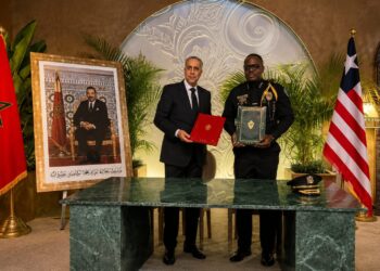 Liberian and Moroccan officials pose with signed documents during a diplomatic meeting focused on bilateral cooperation and security relations.