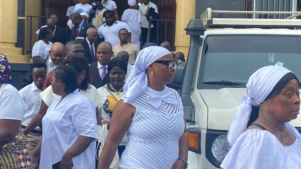 Prayer warriors escort former Chief of Protocol Nora Bondo to Criminal Court C at the Temple of Justice in Monrovia during a hearing in her corruption case.