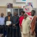 Officials from the Liberia Telecommunications Authority present a mobile money operating license to representatives of Vita Money in Monrovia.