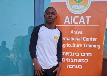 Liberian journalist and agriculture student Josiah Pailay standing at the Arava International Center for Agricultural Training in Israel.