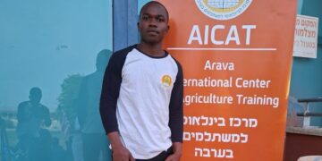Liberian journalist and agriculture student Josiah Pailay standing at the Arava International Center for Agricultural Training in Israel.