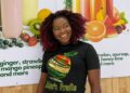 Mariam Mako Meiplay, founder of Mako's Fruit, displays a fresh fruit platter and healthy lifestyle products in Liberia.