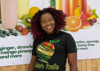 Mariam Mako Meiplay, founder of Mako's Fruit, displays a fresh fruit platter and healthy lifestyle products in Liberia.