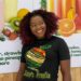 Mariam Mako Meiplay, founder of Mako's Fruit, displays a fresh fruit platter and healthy lifestyle products in Liberia.