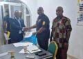 Officials of the Center for Justice and Peace Studies and the Liberia Drug Enforcement Agency shake hands after signing a memorandum of understanding on drug control and accountability in Liberia.