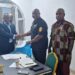 Officials of the Center for Justice and Peace Studies and the Liberia Drug Enforcement Agency shake hands after signing a memorandum of understanding on drug control and accountability in Liberia.