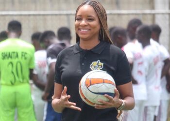 Telia Urey holding a football during a Shaita FC event in Liberia.