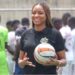 Telia Urey holding a football during a Shaita FC event in Liberia.