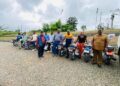 Officials of RDFI and RPAL display newly donated pickup truck and motorcycles intended to support rubber farmers across Liberia