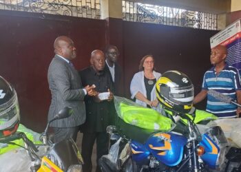 Officials from the United Nations, European Union and INCHR inspect newly donated motorcycles and equipment during a handover ceremony in Monrovia.