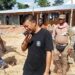 Liberian security officers inspect seized excavators during an illegal mining enforcement operation in Gbarpolu County