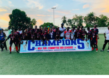 Players and officials of Professional Sports Academy celebrate winning the Montserrado County Third Division League title in Liberia.