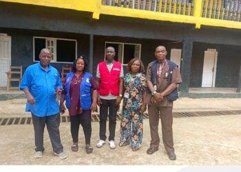 Officials from the Liberia Revenue Authority, Ministry of Education and WAEC pose during a school compliance enforcement exercise.