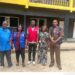 Officials from the Liberia Revenue Authority, Ministry of Education and WAEC pose during a school compliance enforcement exercise.