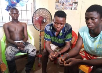 Three robbery suspects seated in custody after being charged by police in connection with a knife-point robbery case in Gbarnga, Bong County.