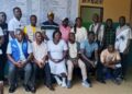 Officials unveil a hospital fee transparency billboard at C.B. Dunbar Hospital in Gbarnga to improve accountability and public awareness of approved medical fees.
