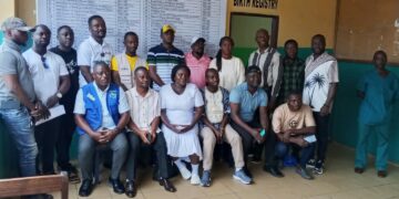 Officials unveil a hospital fee transparency billboard at C.B. Dunbar Hospital in Gbarnga to improve accountability and public awareness of approved medical fees.