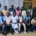 Officials unveil a hospital fee transparency billboard at C.B. Dunbar Hospital in Gbarnga to improve accountability and public awareness of approved medical fees.
