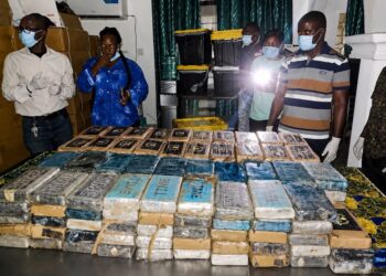 Liberian drug enforcement officers display hundreds of cocaine packages seized at Roberts International Airport during a major anti-narcotics operation.