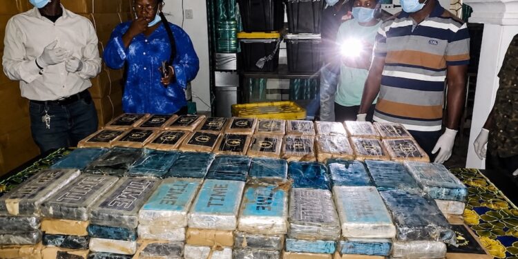 Liberian drug enforcement officers display hundreds of cocaine packages seized at Roberts International Airport during a major anti-narcotics operation.