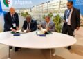 Finance Minister Augustine Ngafuan and BADEA President Abdullah Almusaibeeh sign a $30 million agreement for the Salayea-Konia road project in Vienna