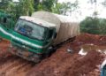 A truck stuck in deep mud on a damaged road in Grand Gedeh County, southeastern Liberia.