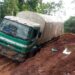 A truck stuck in deep mud on a damaged road in Grand Gedeh County, southeastern Liberia.