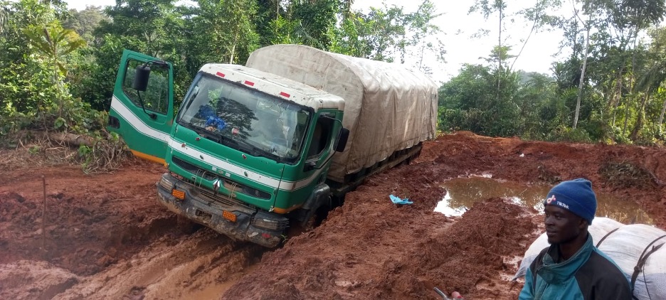 A truck stuck in deep mud on a damaged road in Grand Gedeh County, southeastern Liberia.