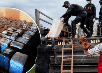 Liberian security officers remove suspected cocaine from a warehouse during a raid in Duazon, Margibi County.
