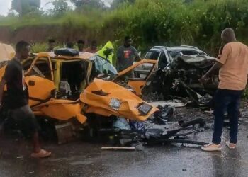 Traffic officers respond to a serious road crash on a Liberian highway as emergency responders assist victims.