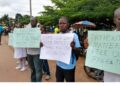 Health workers protest outside the Gbarnga Central Police Station during the Phebe Hospital labor dispute.