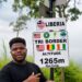 Ghanaian YouTuber Wodemaya standing at the Liberia-Guinea-Ivory Coast tripoint in Nimba County.