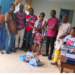 Edwin Kidjlay presents medical supplies to residents of Buah Statutory District in Grand Kru County.