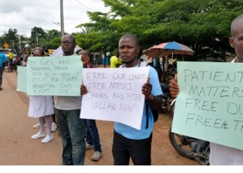 Health workers protest outside the Gbarnga Central Police Station during the Phebe Hospital labor dispute.