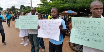 Health workers protest outside the Gbarnga Central Police Station during the Phebe Hospital labor dispute.