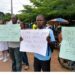 Health workers protest outside the Gbarnga Central Police Station during the Phebe Hospital labor dispute.