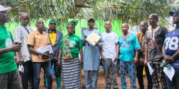 Officials of the Liberia Land Authority present a customary land deed to residents of Karzah Section in Lofa County.