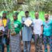 Officials of the Liberia Land Authority present a customary land deed to residents of Karzah Section in Lofa County.