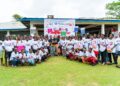 British Ambassador Paul Richard Simister in a group photo with girls at the LIFE football camp
