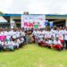 British Ambassador Paul Richard Simister in a group photo with girls at the LIFE football camp