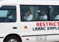Officials receive foreign nationals transferred from the United States at Roberts International Airport in Liberia.