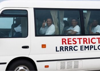 Officials receive foreign nationals transferred from the United States at Roberts International Airport in Liberia.