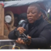 STAND chairman Mulbah K. Morlu displays a firearm during the July 17 protest in Monrovia.