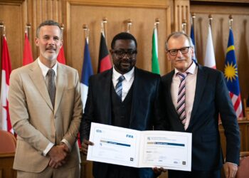 Jlayteh Sayor poses after graduating from the FIFA Master postgraduate program in sports administration.